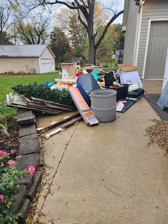 Dumpster being loaded with debris for Estate Cleanout Dumpster Rental in Colon